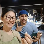 Happy student proudly posing with his first handmade silver ring