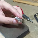 Jewelry student proudly displaying a handmade ring